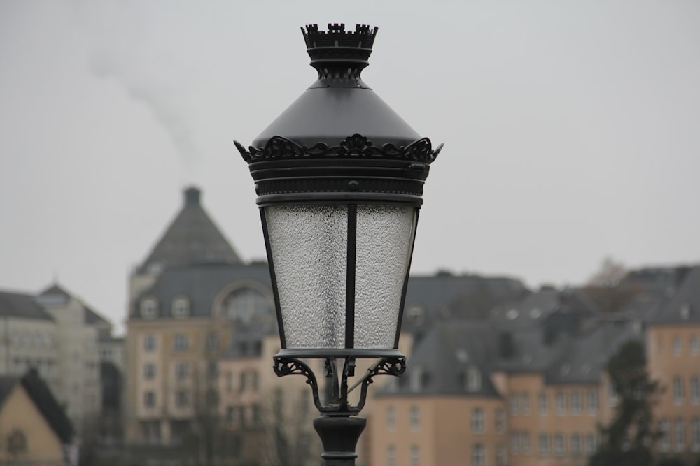 a lamp post with a building in the background