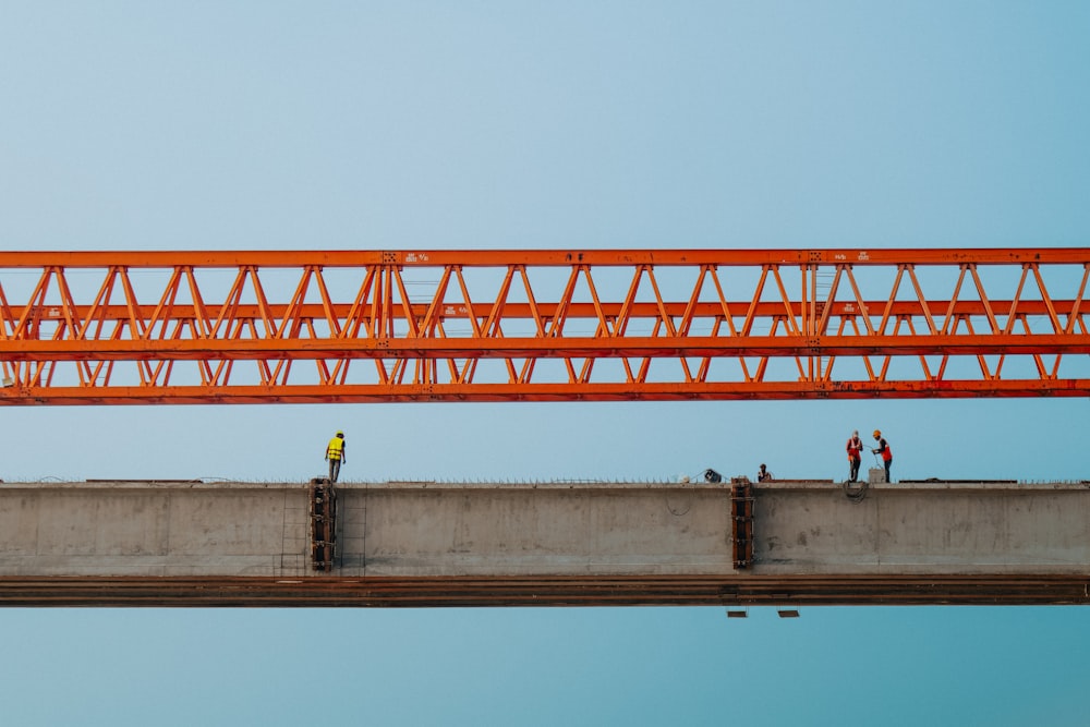 a group of people standing on top of a bridge