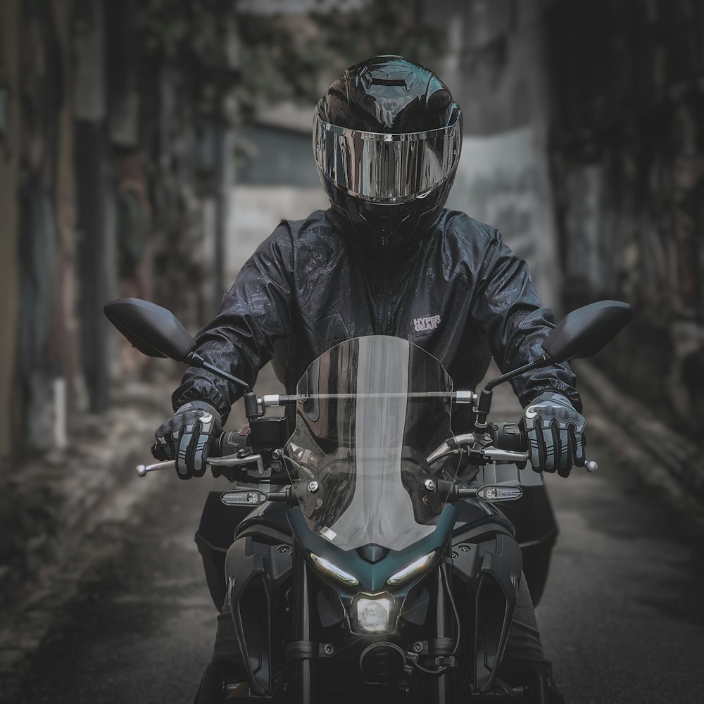 a person wearing a helmet and riding a motorcycle