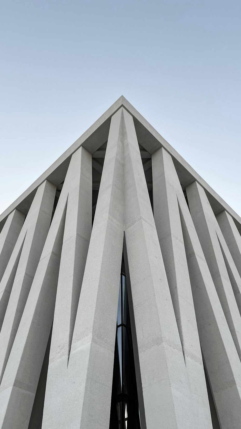 a tall white building with a sky background