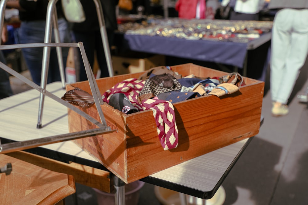 a wooden box filled with ties on top of a table