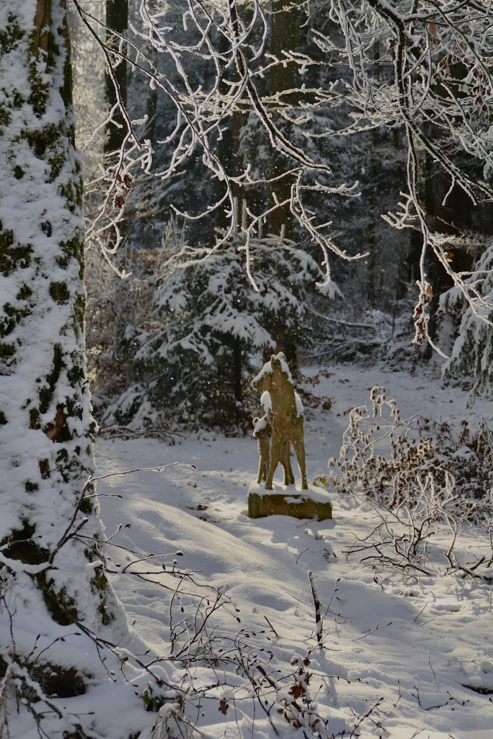 Una estatua en medio de un bosque nevado