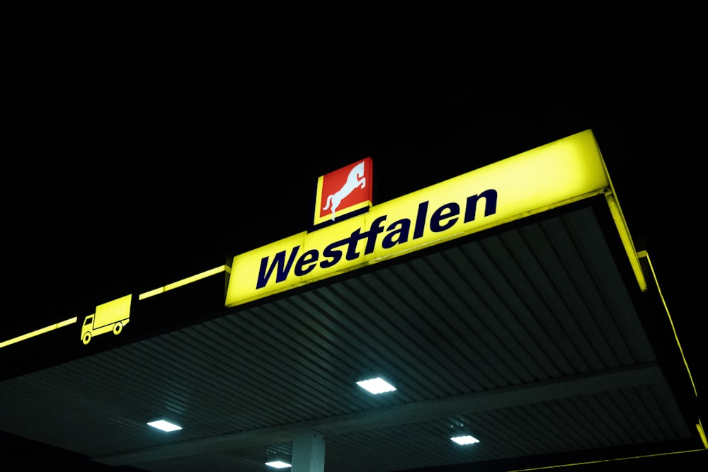 a gas station sign lit up at night