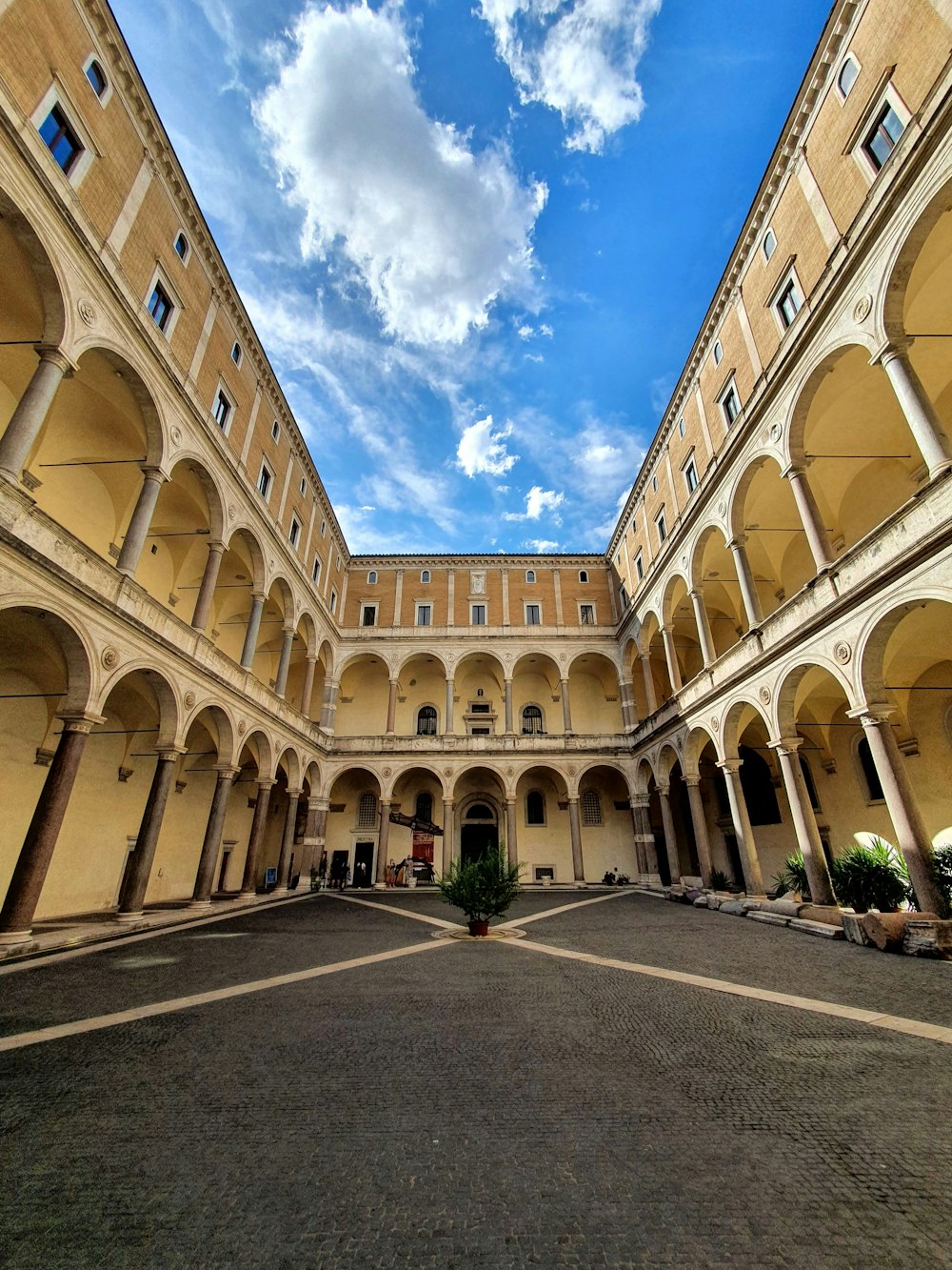 a courtyard of a building with arches and arches