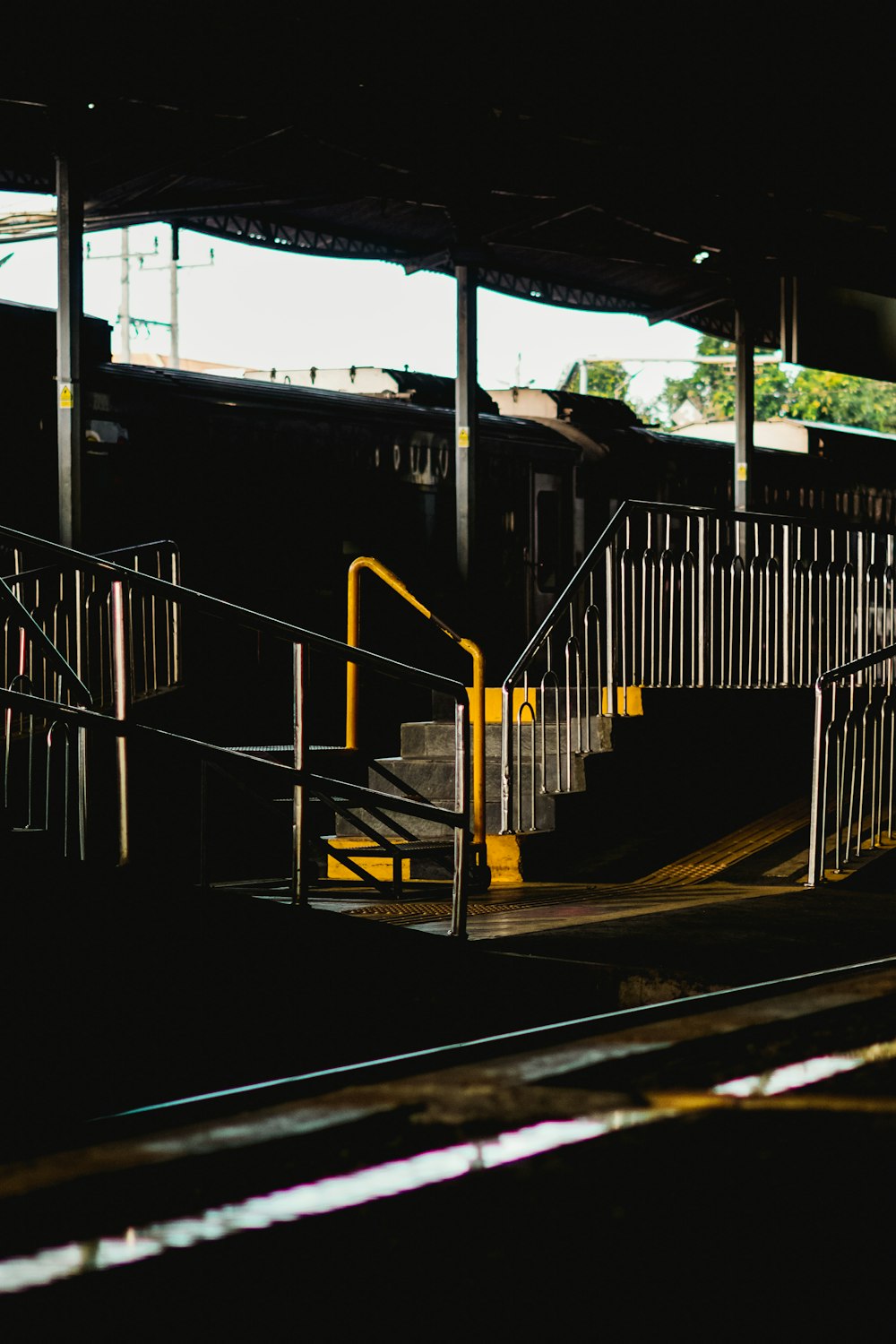 a set of stairs leading up to a train station