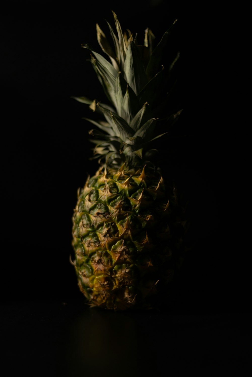 a pineapple sitting on a table in the dark