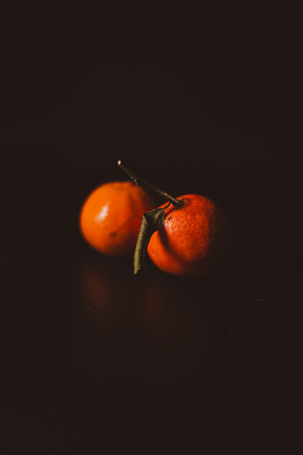 a couple of oranges sitting on top of a table