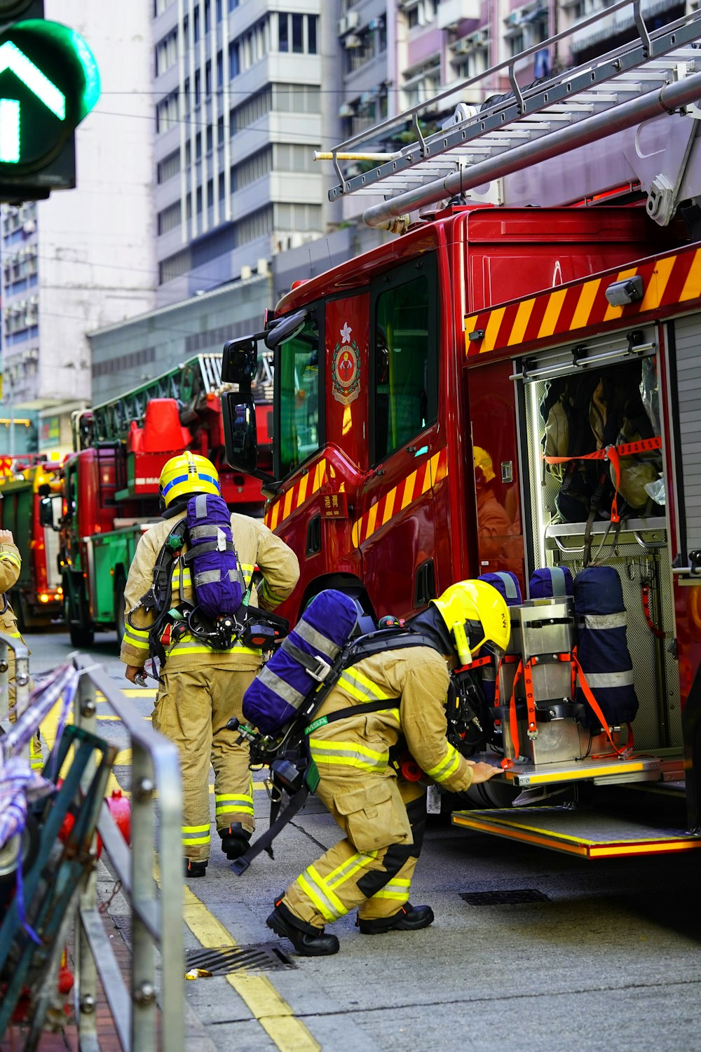 a group of firemen standing next to a fire truck