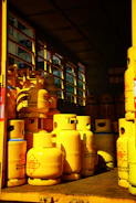 a yellow truck filled with yellow gas bottles