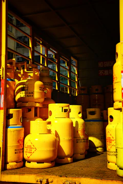 a yellow truck filled with yellow gas bottles