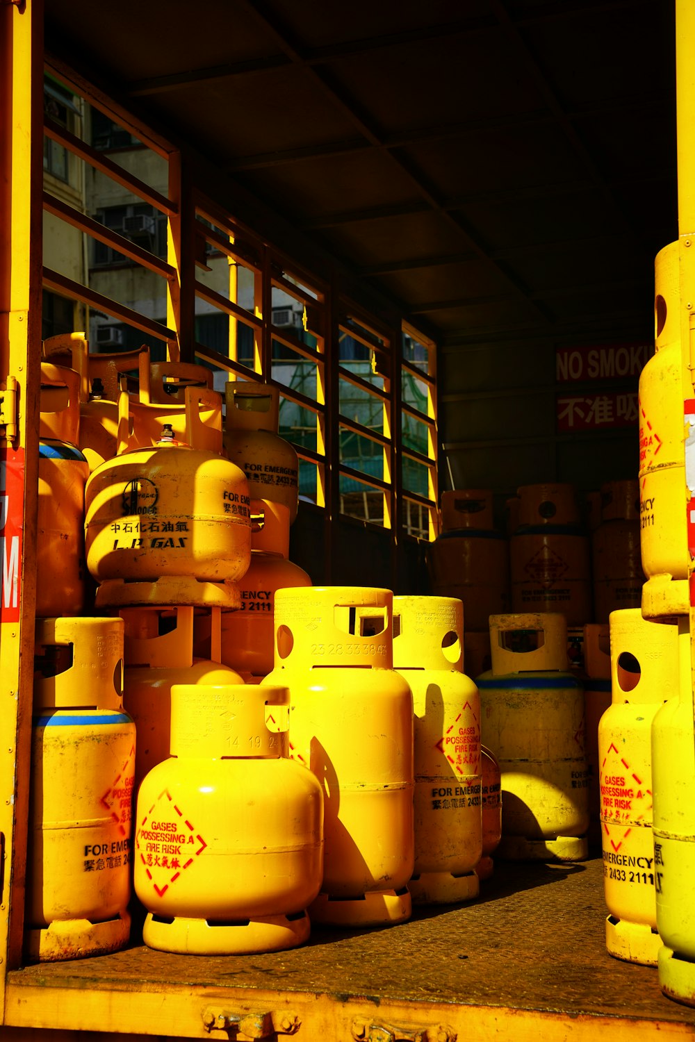 a yellow truck filled with yellow gas bottles