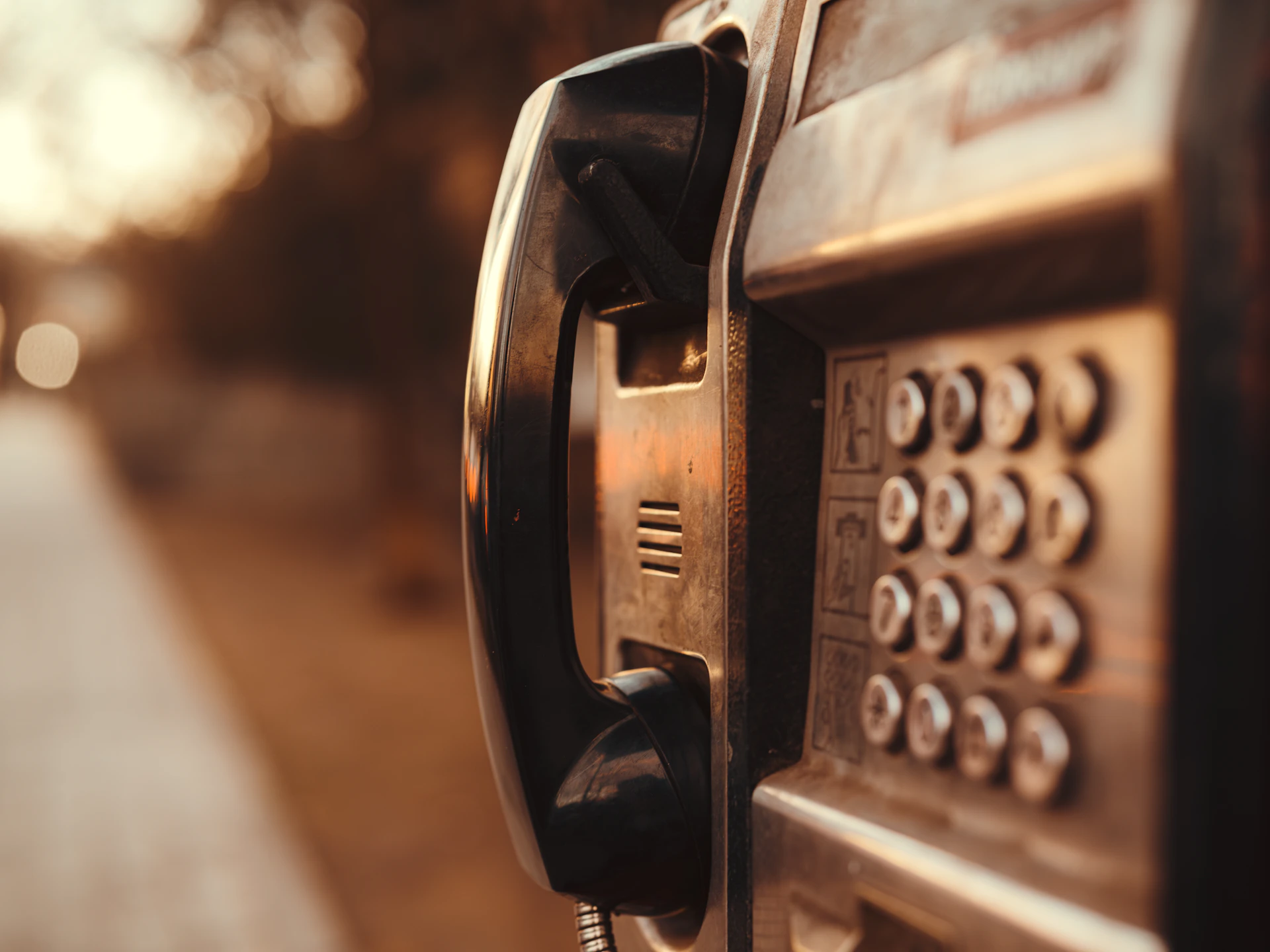 a close up of an old fashioned pay phone
