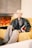 a man sitting on a couch in front of a fireplace