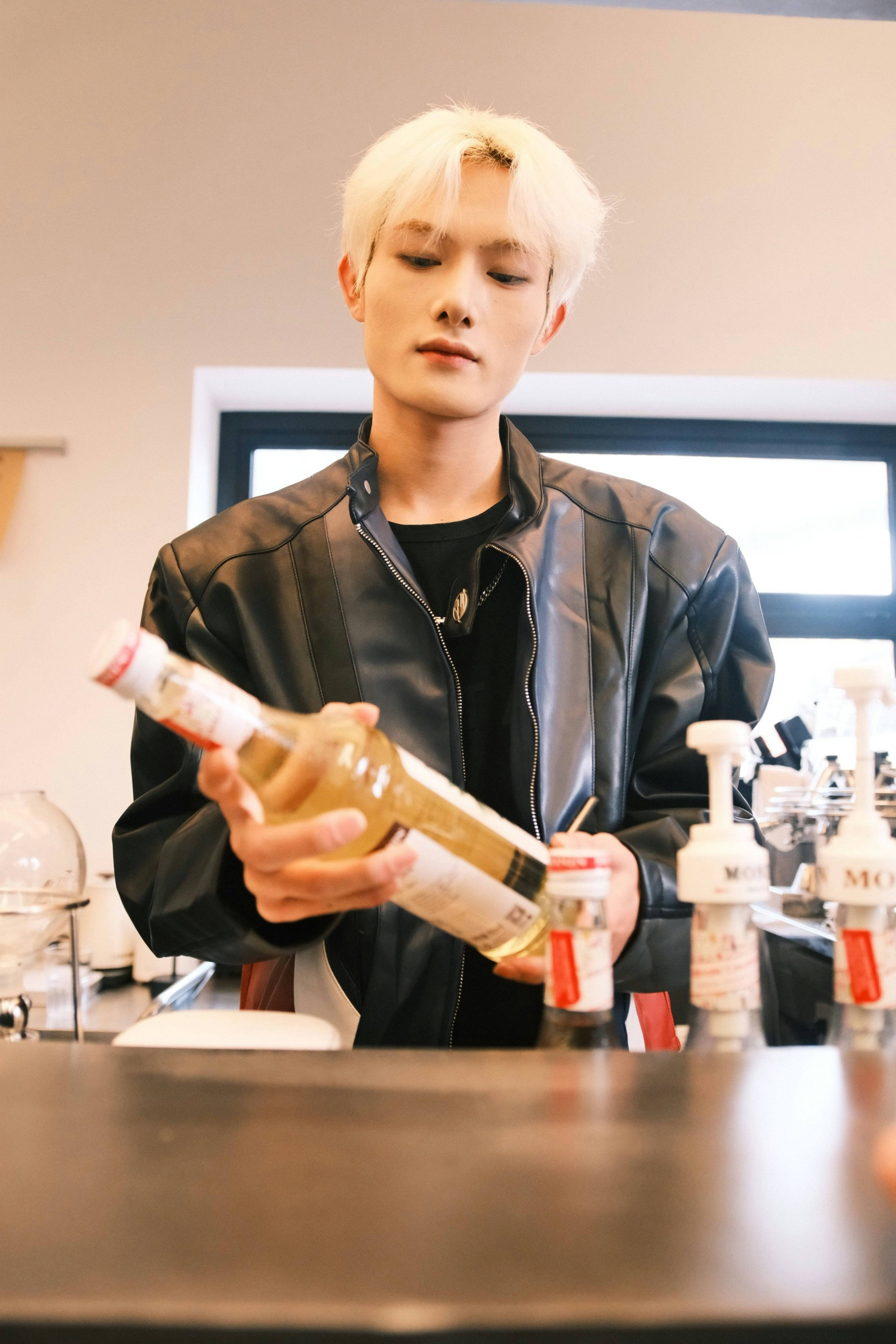 a man holding a bottle of wine in his hand