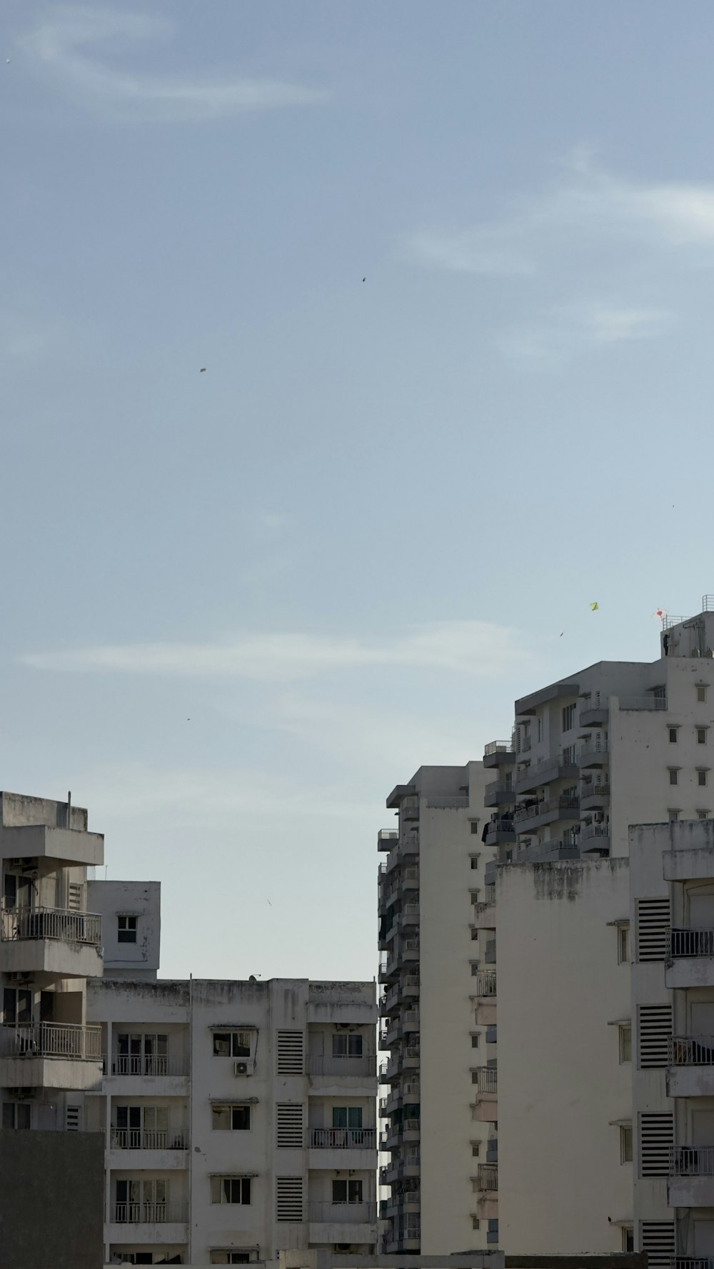 a tall white building with balconies and balconies