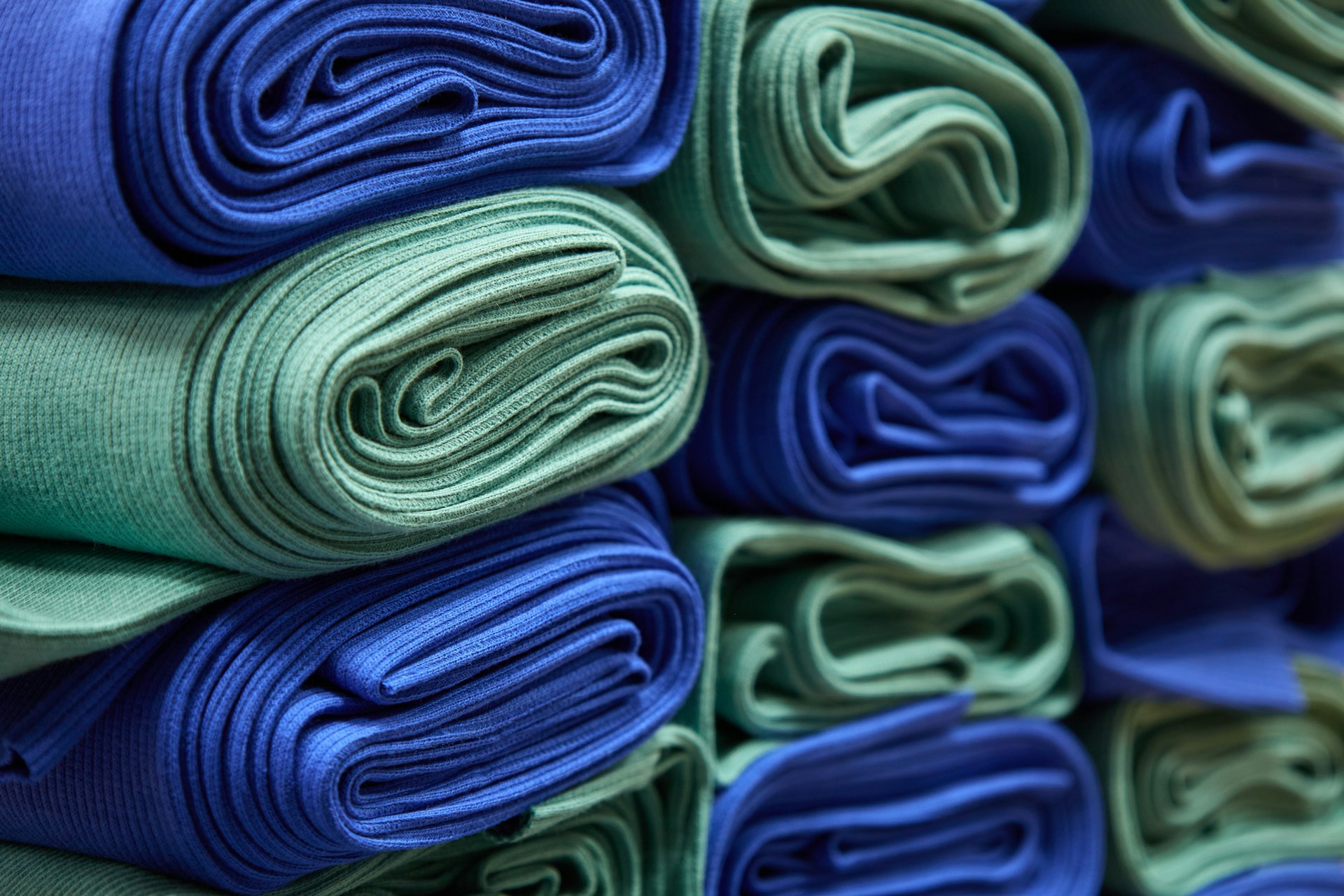 a stack of folded blue and green cloths