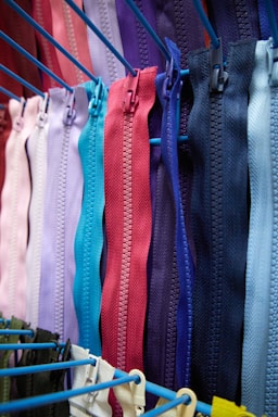 a bunch of colorful zippers hanging on a rack