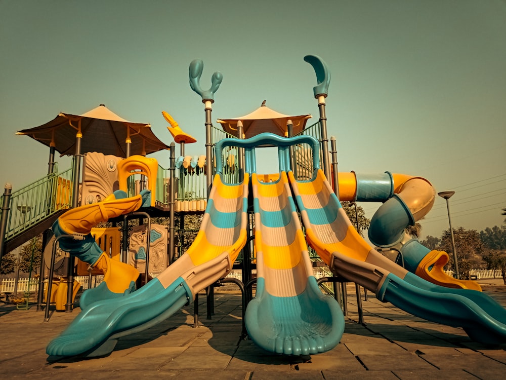 a playground with a slide and a play structure