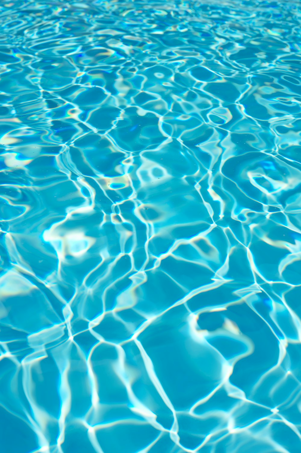 a pool with blue water and ripples of water