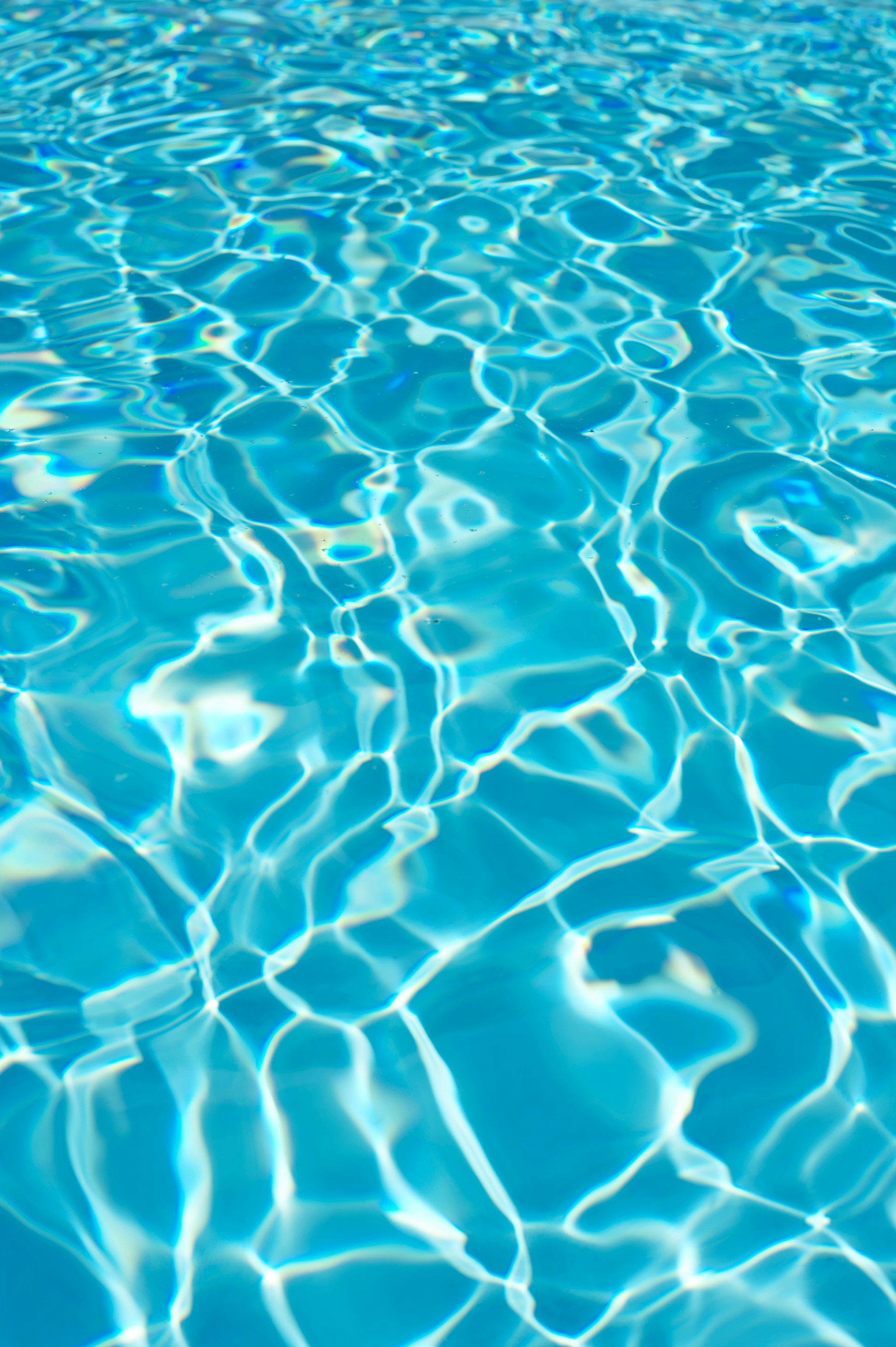 a pool with blue water and ripples of water