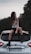 a woman sitting on the back of a car