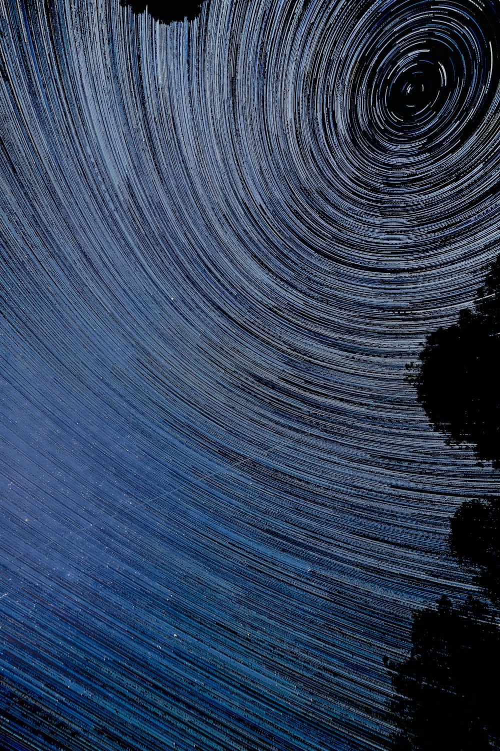 a star trail is seen in the night sky