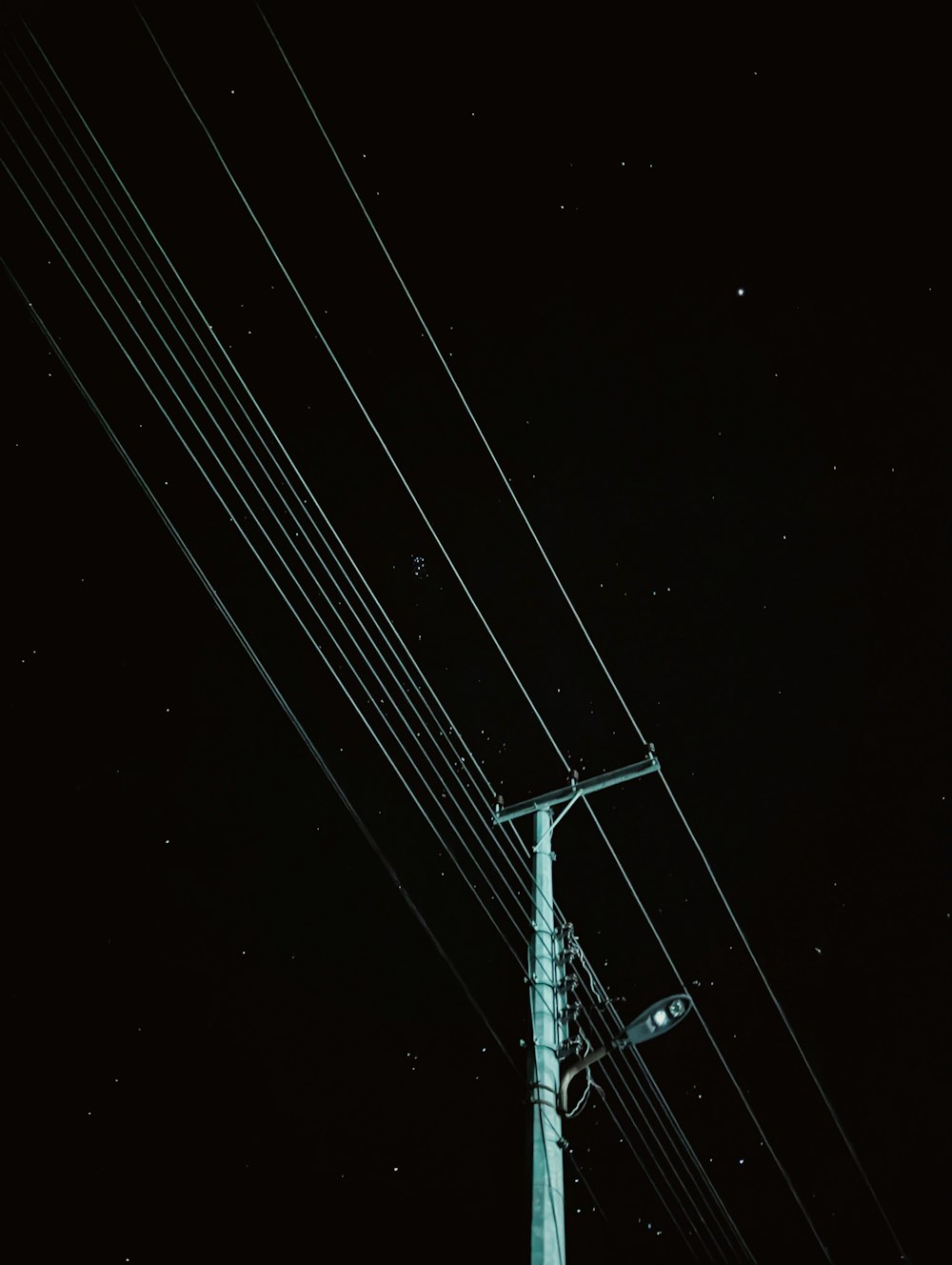 a telephone pole and a street light at night