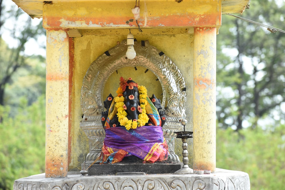 a statue of a person sitting on a bench