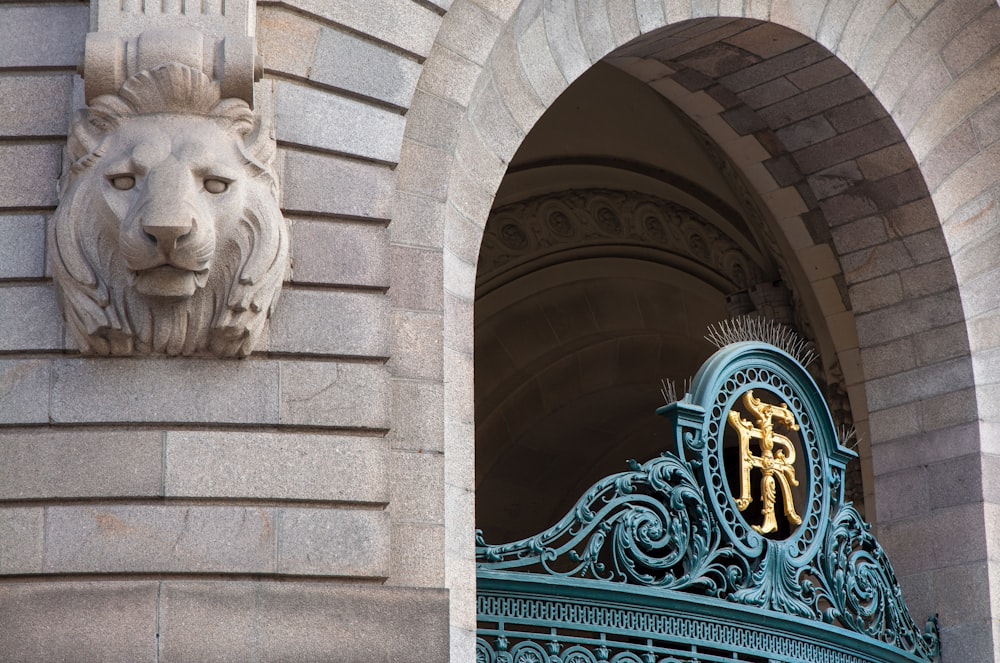 a lion head on the side of a building