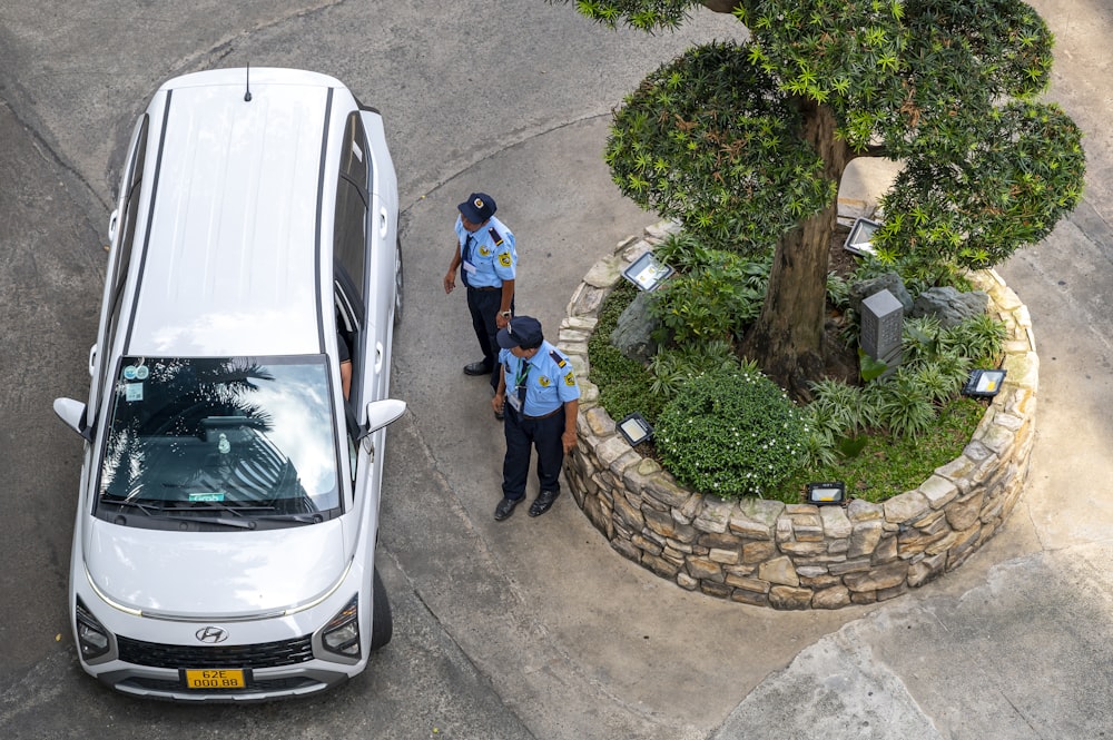 two police officers standing next to a white van