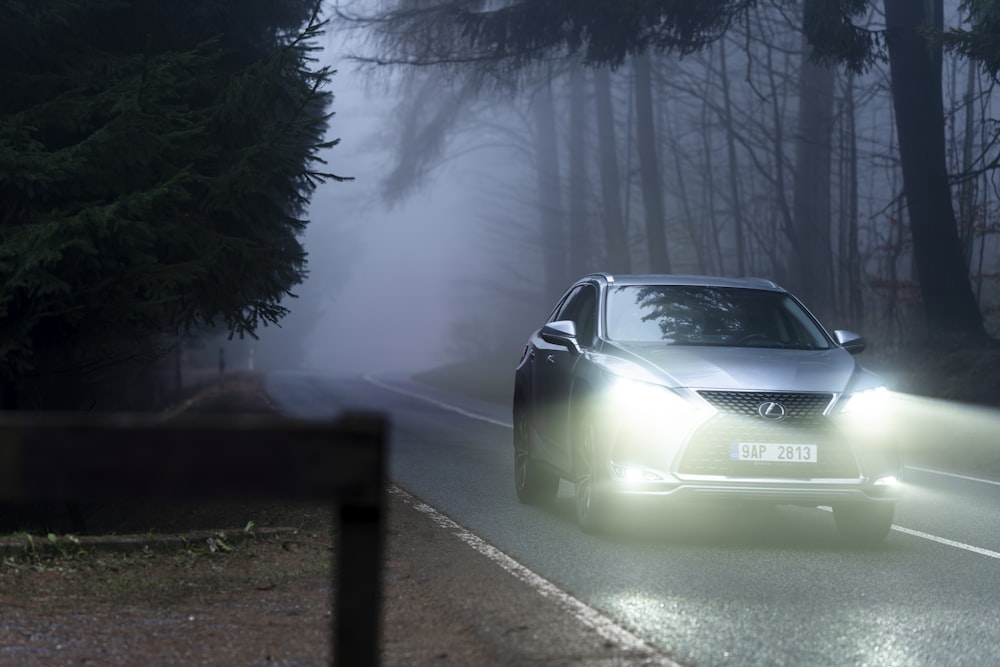 a car driving down a road in the fog