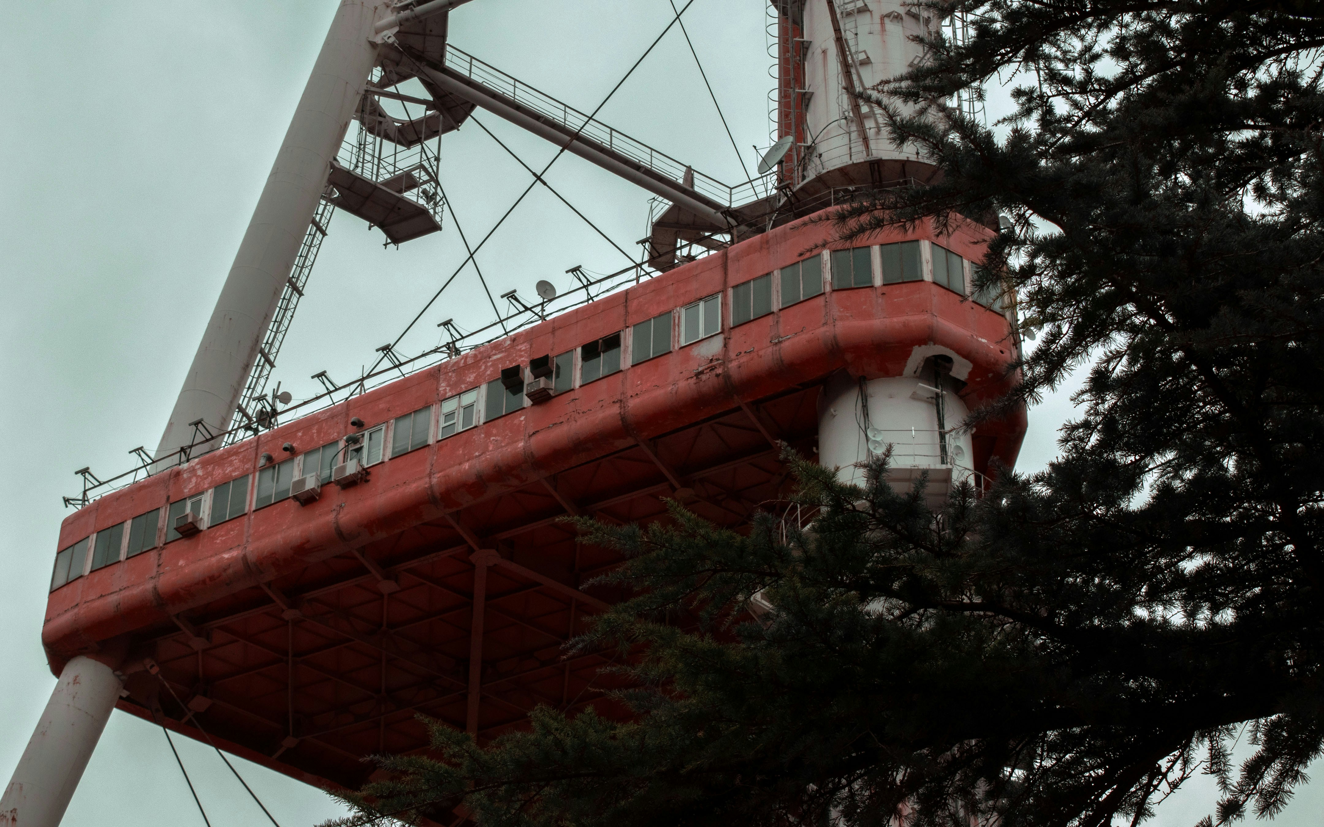 a red structure with birds perched on top of it