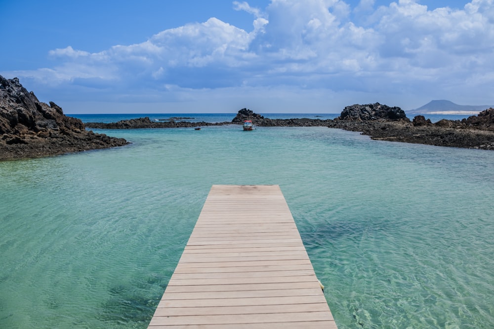 a wooden dock in the middle of a body of water