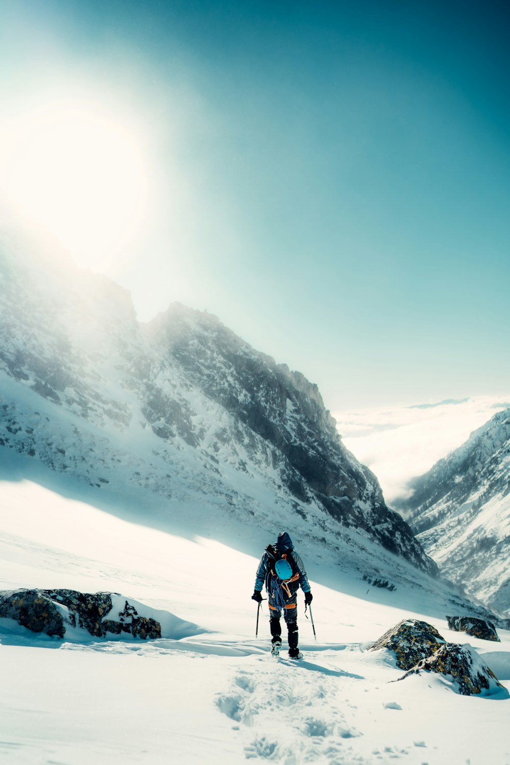 a man hiking up a snow covered mountain