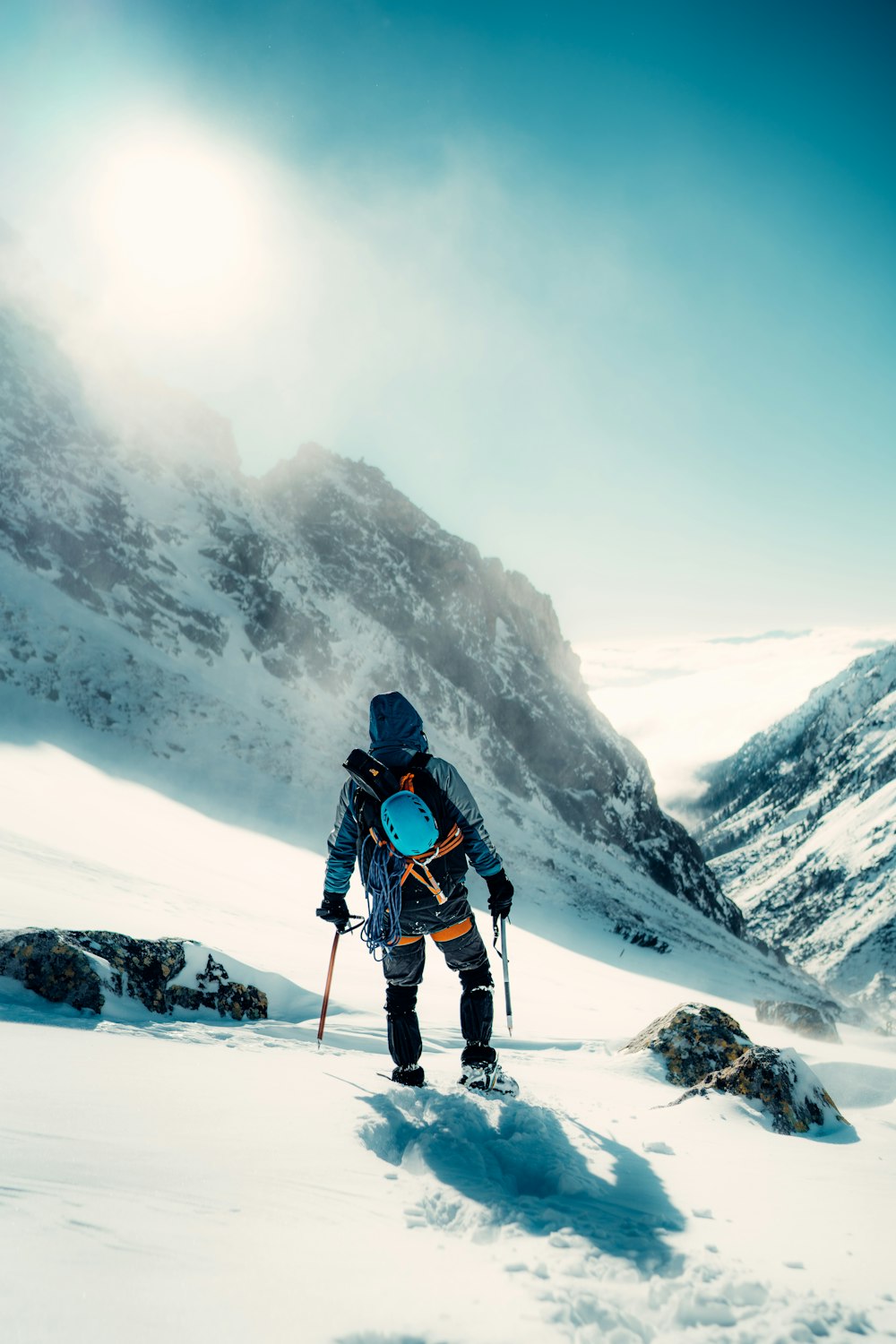a man hiking up a snow covered mountain