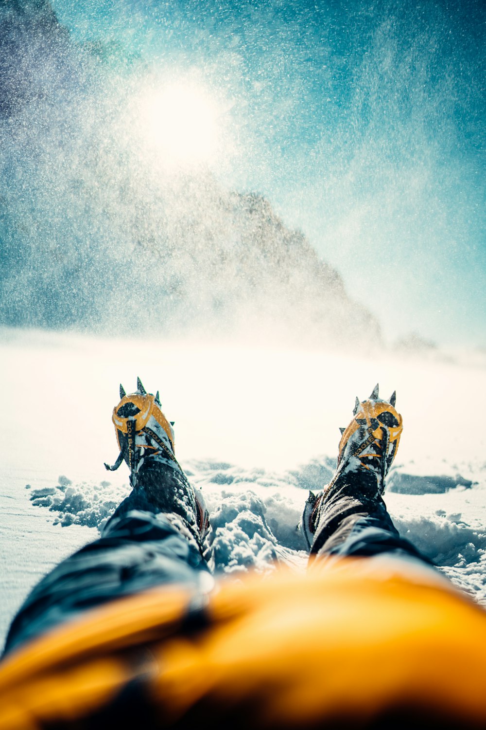 a pair of feet in the snow on a sunny day