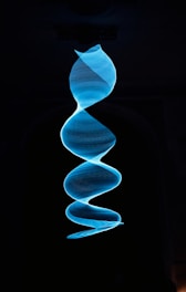 a spiral of blue smoke in the dark