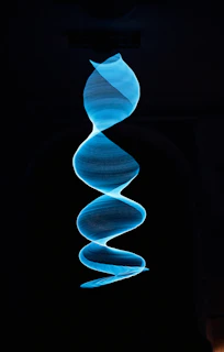 a spiral of blue smoke in the dark
