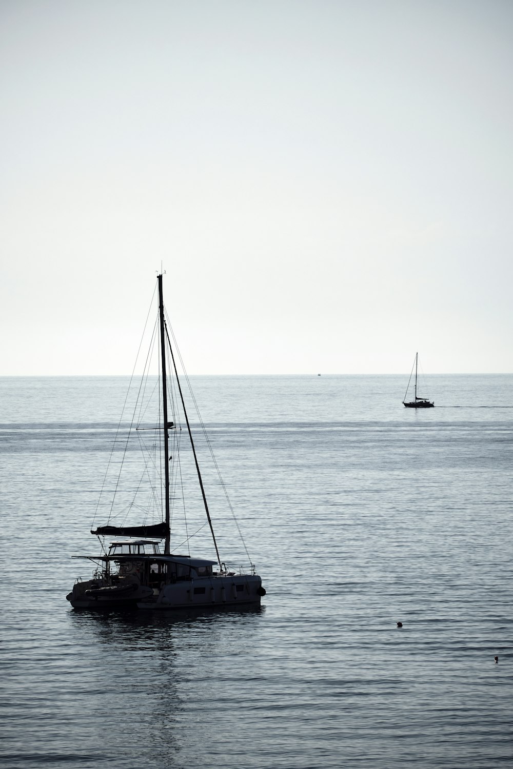 a sailboat floating in the middle of the ocean