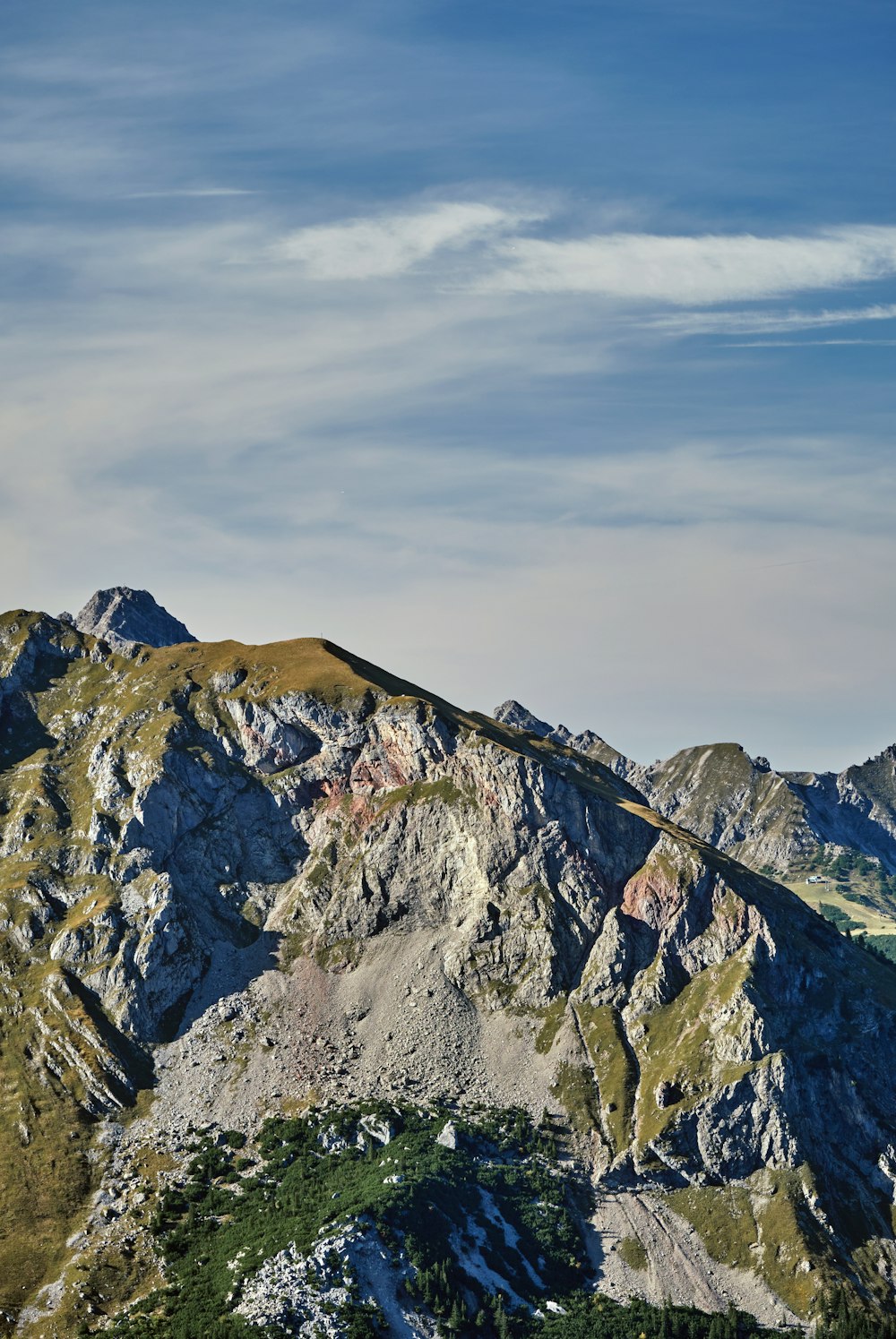 a view of a mountain range from the top of a hill