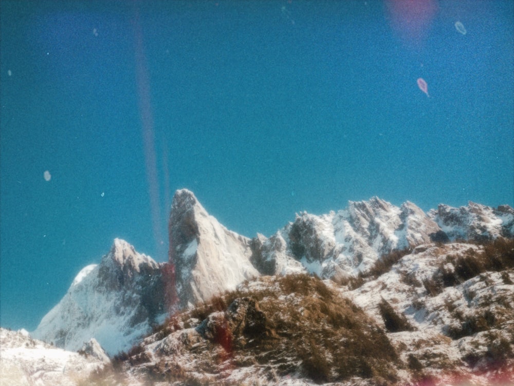 a snow covered mountain with a blue sky in the background