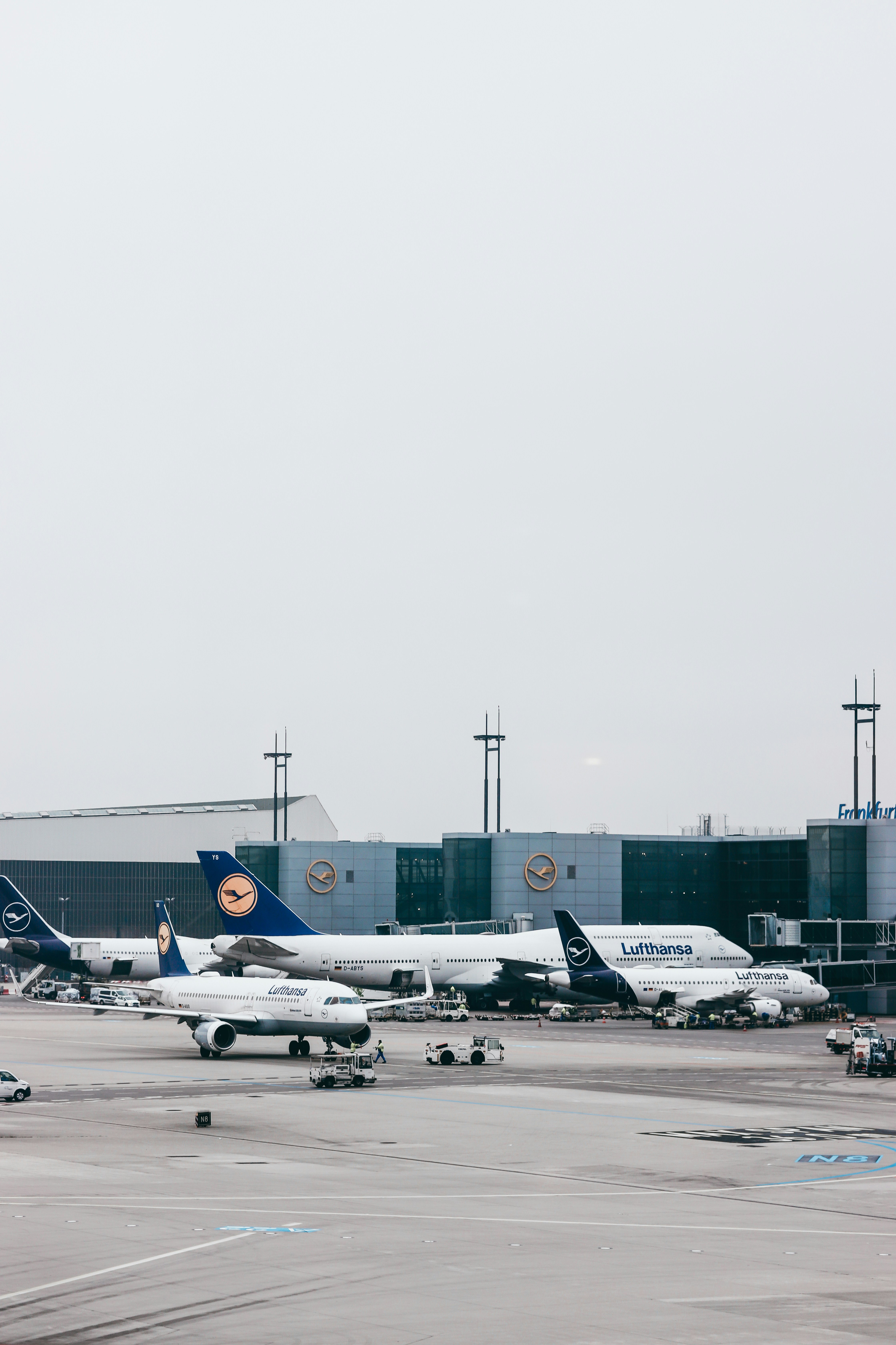 a group of airplanes sitting on top of an airport tarmac