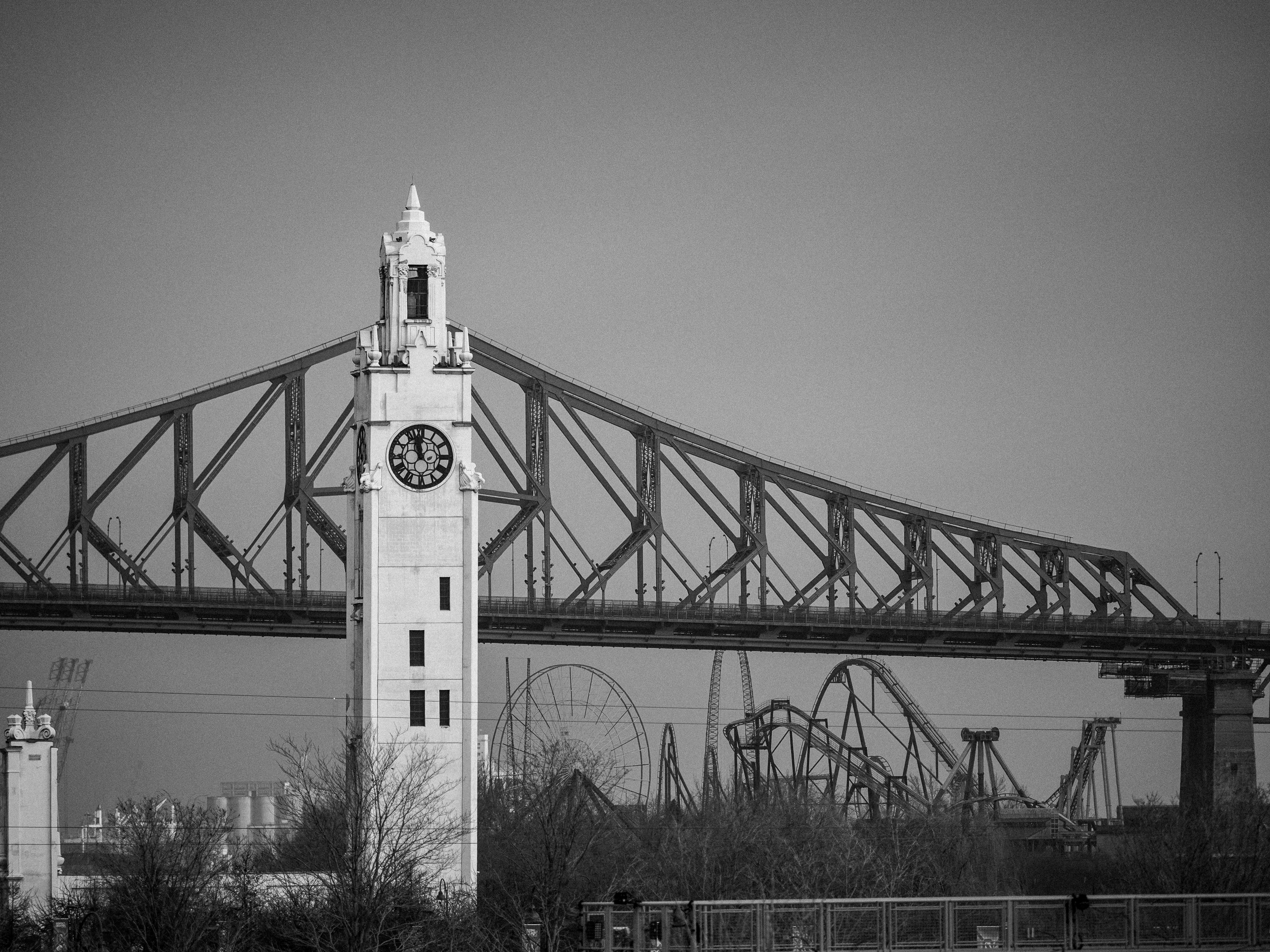 a tall clock tower sitting under a bridge