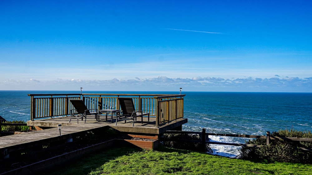 a deck with chairs overlooks the ocean