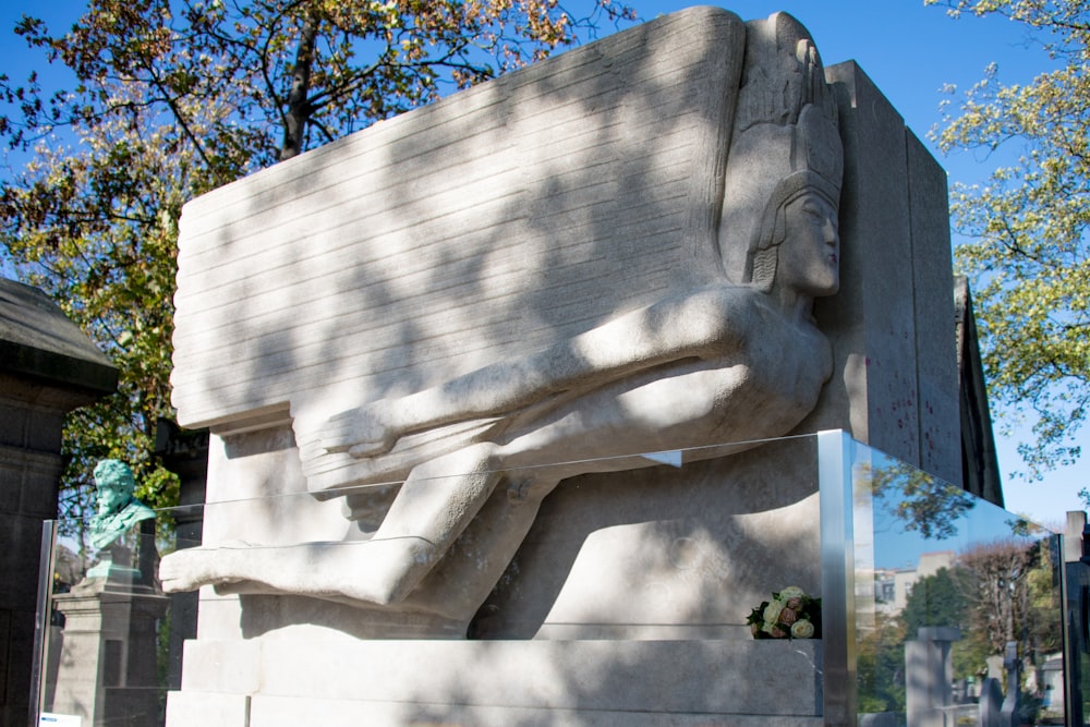 a statue of a person holding a suitcase