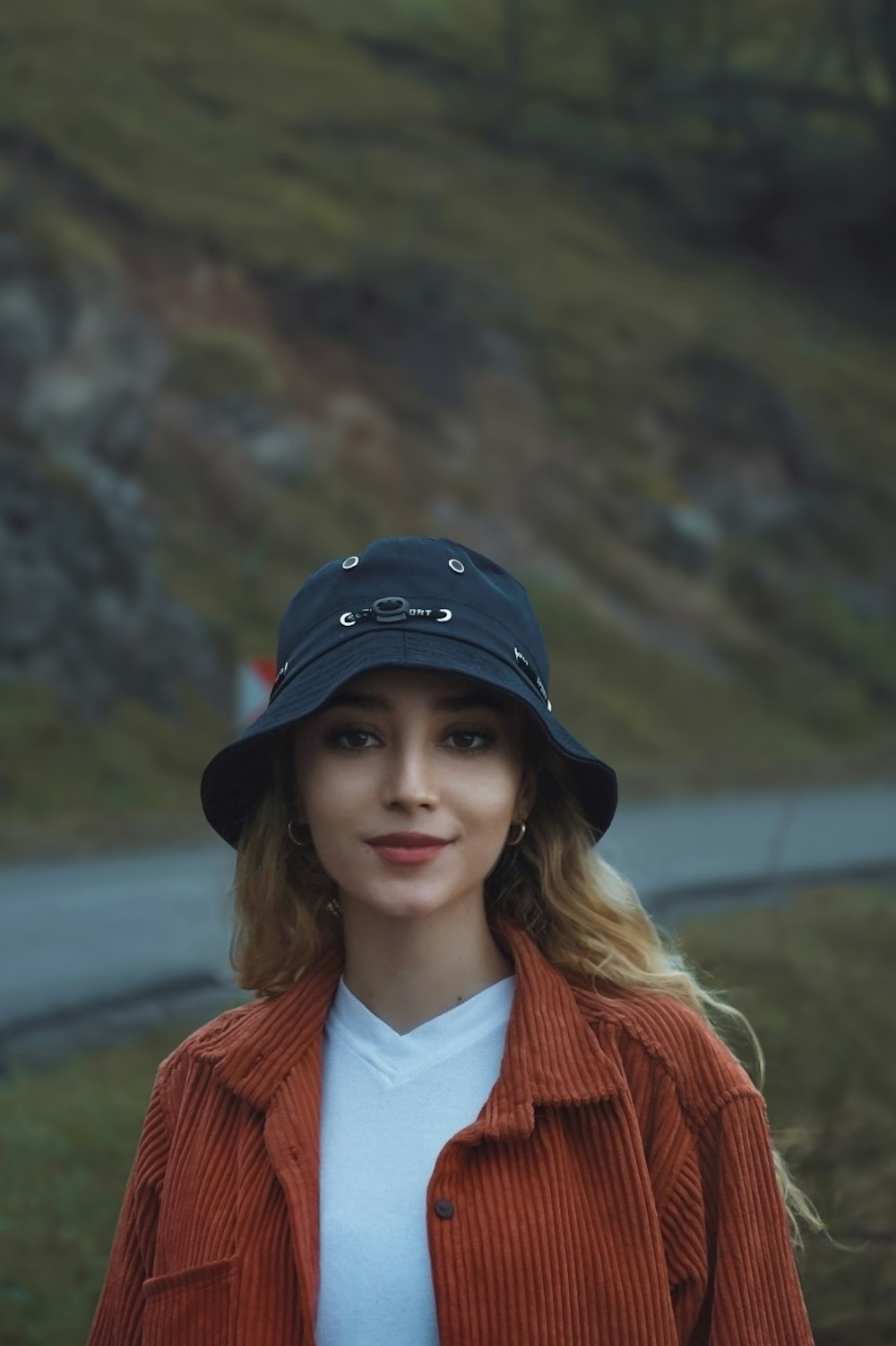 a woman wearing a red jacket and a black hat