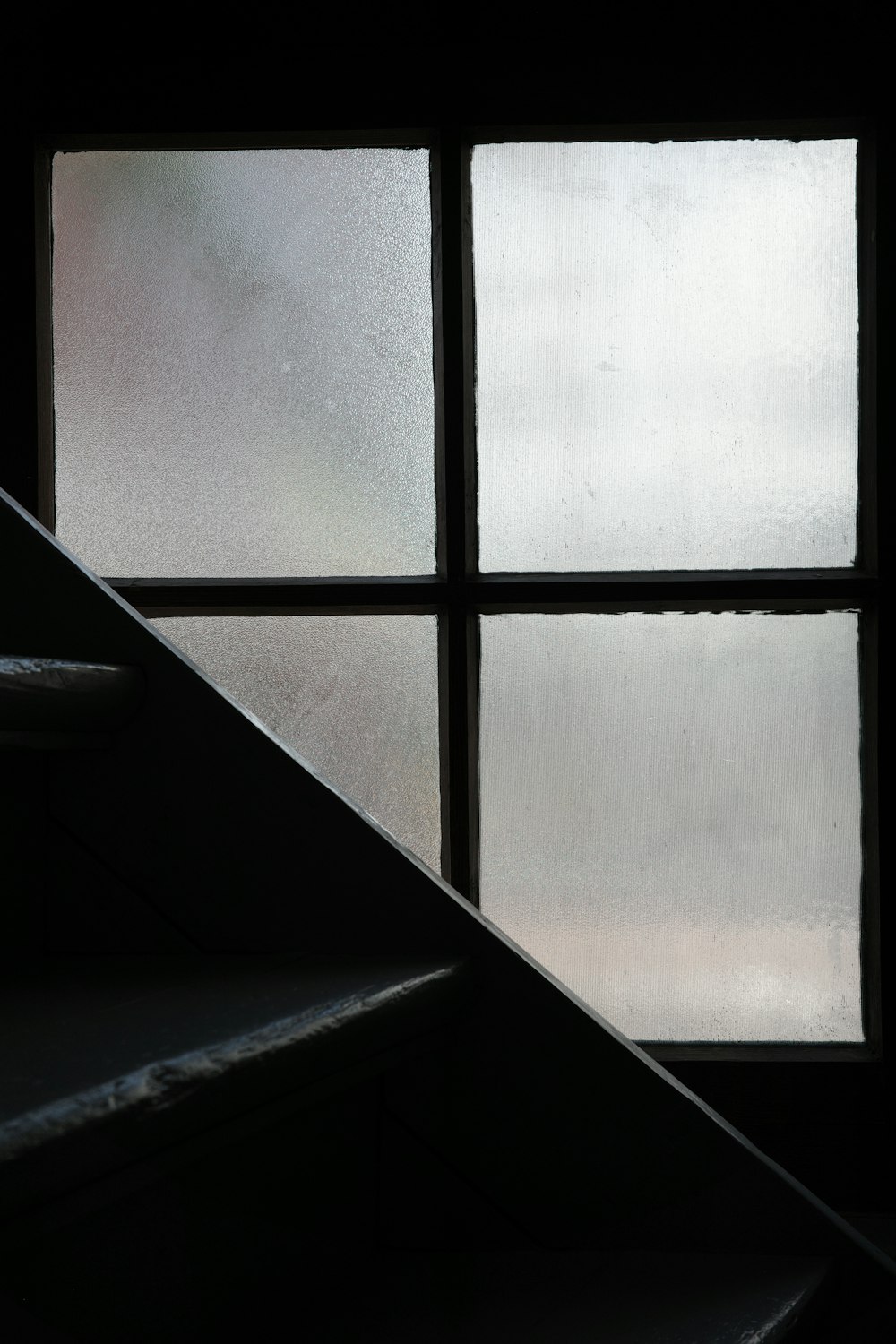 a window with a stair case in front of it