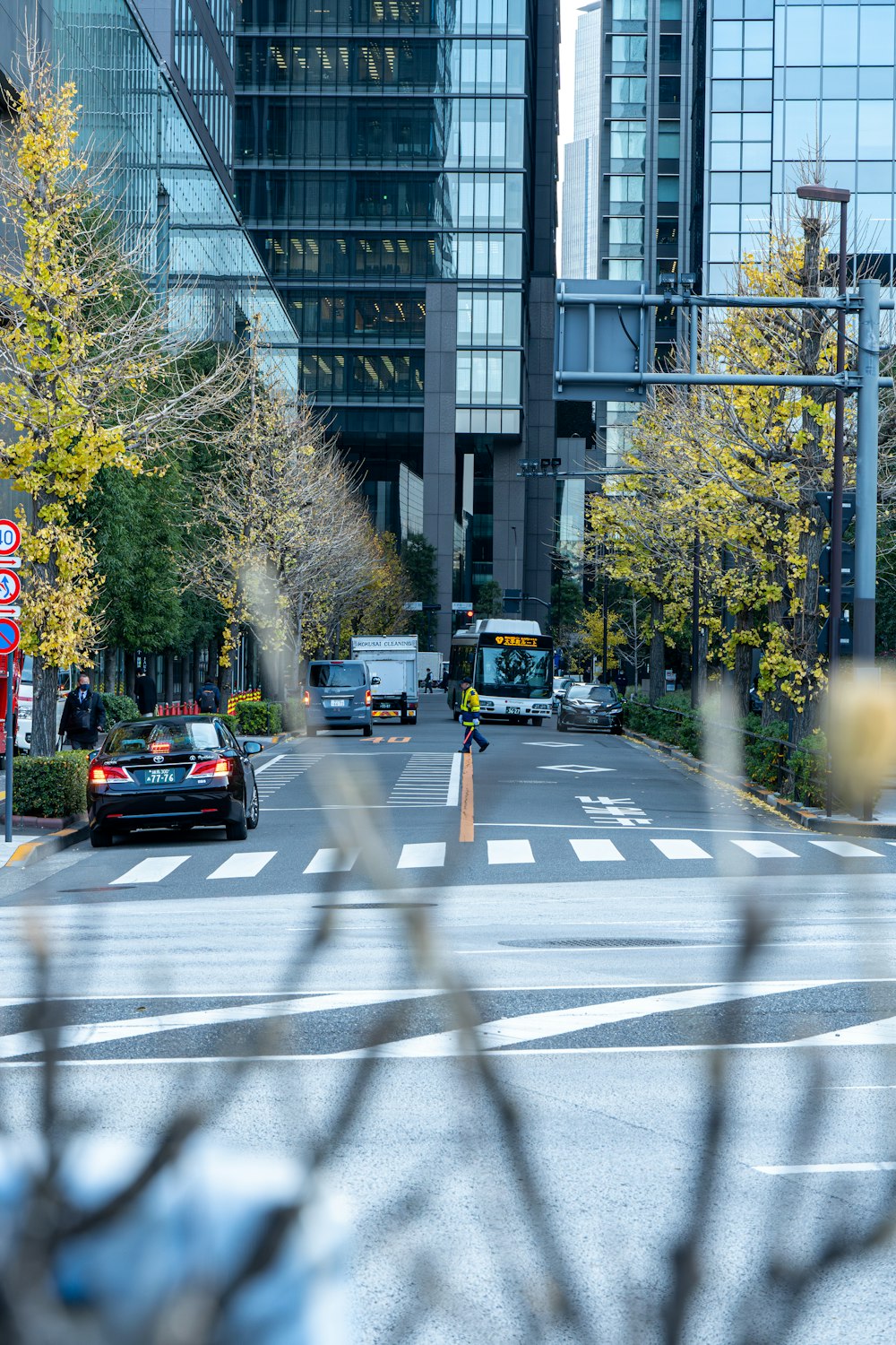 a city street filled with traffic next to tall buildings