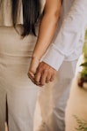 a close up of a person holding the hand of another person