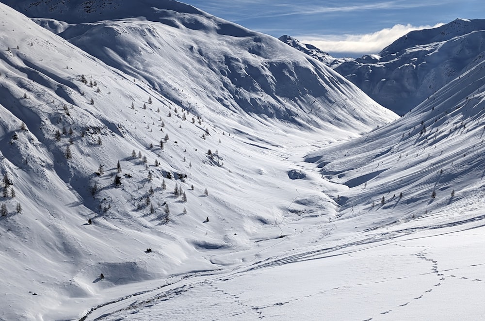 a man riding skis down a snow covered slope